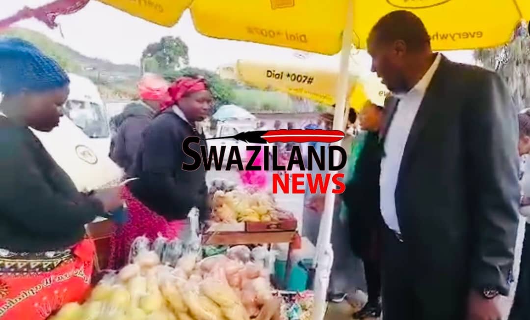 Prime Minister Russell Dlamini buys from street vendors at Mankayane after inspecting Sports Ground’s readiness for King’s Birthday.