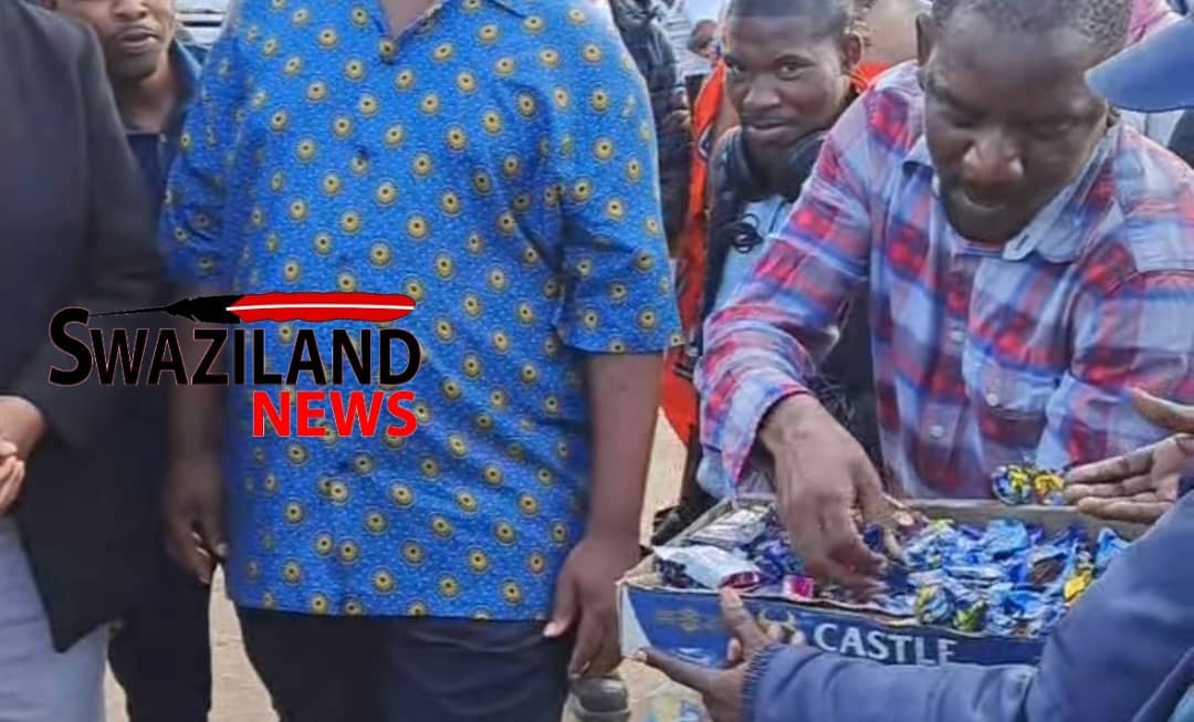 Mankayane street vendor Thabo Sibandze who was happy to see Prime Minister Russell Dlamini gives him free sweets