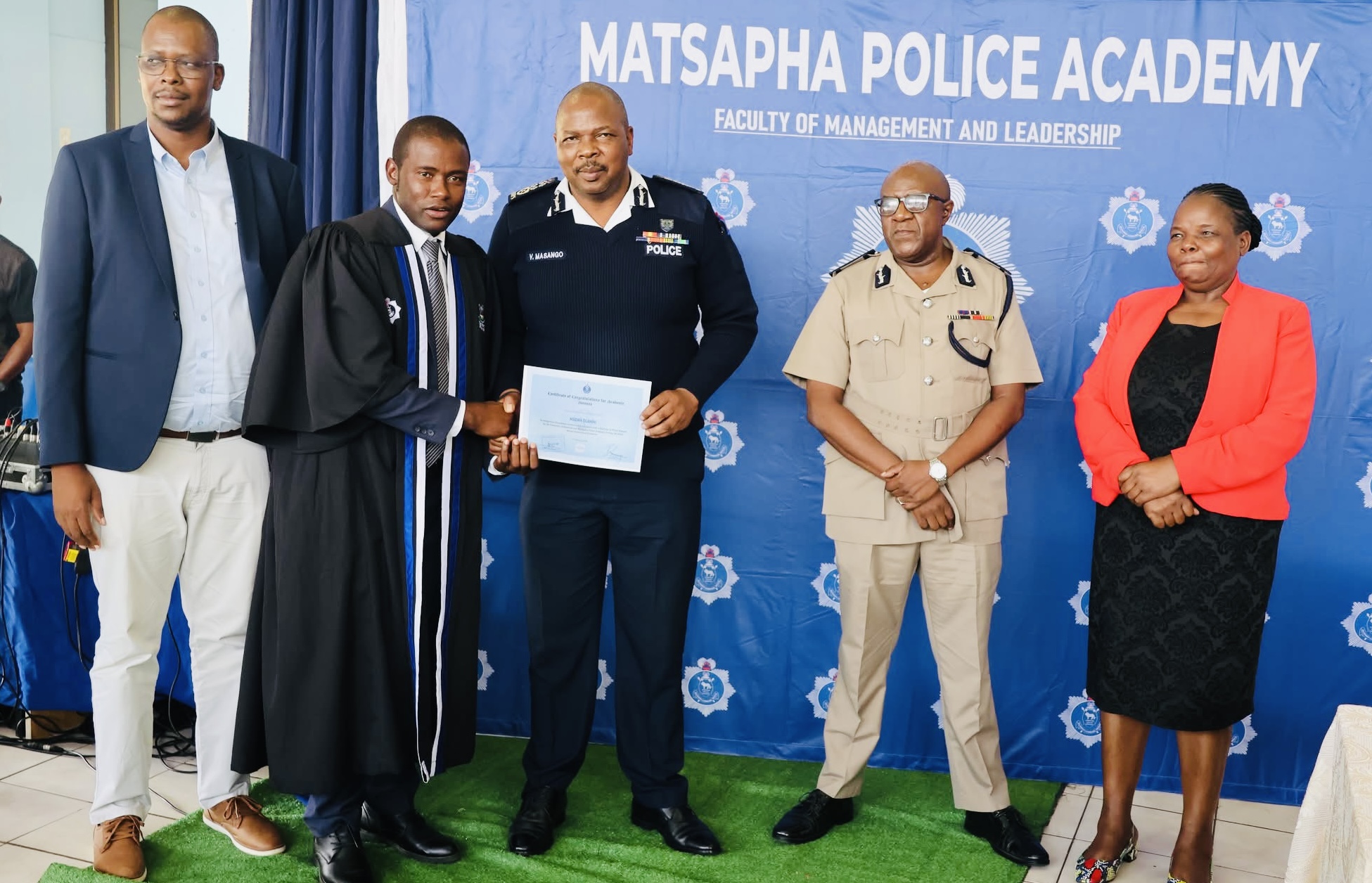 National Commissioner of Police Vusi Masango hands over certificates to twenty-seven (27) Diploma in Police Science UNESWA graduates.